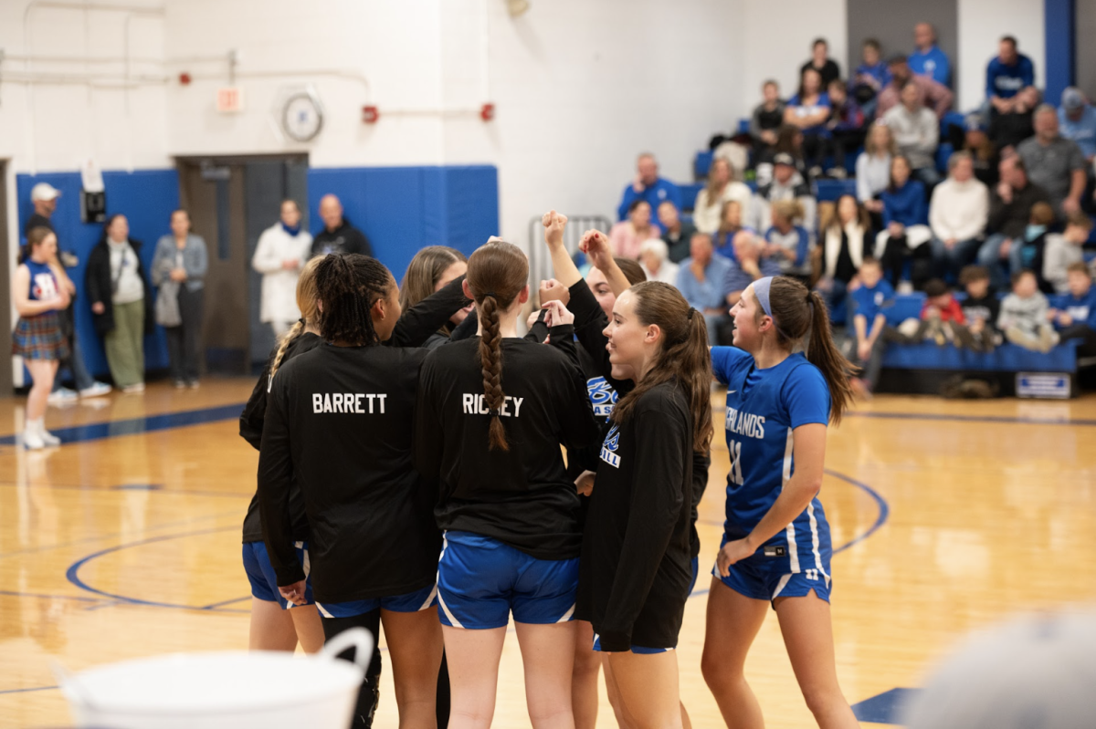 The blue team huddles up before the Varsity scrimmage.